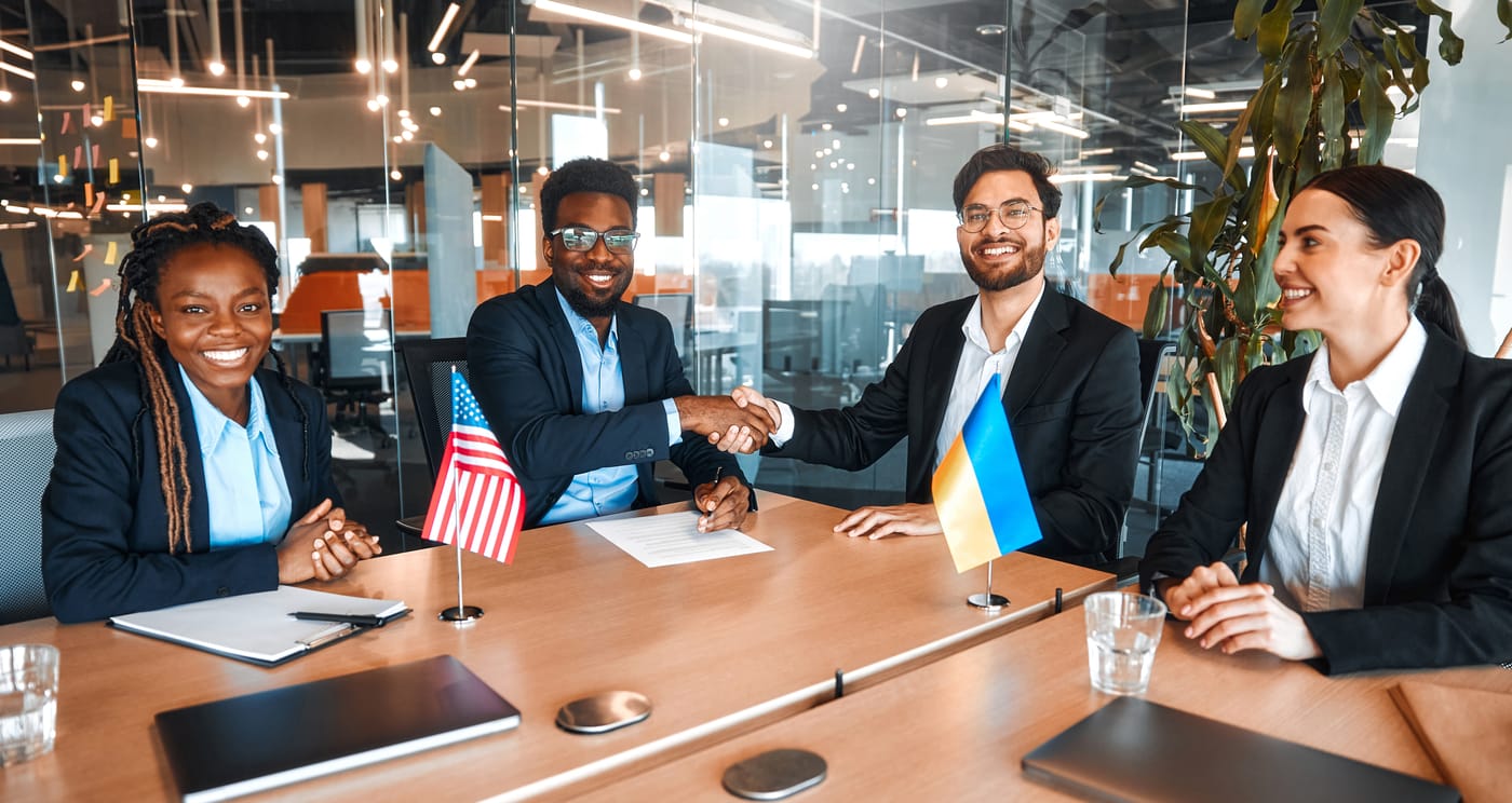 Evoluz and client teams shaking hands after a successful Dynamics 365 to Zoho migration